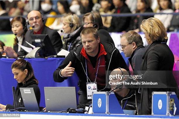 Staffs discuss as theri scoring system is down during day two of the ISU Grand Prix of Figure Skating 2013/2014 NHK Trophy at Yoyogi National...