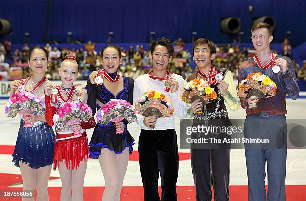 Ladies' bronze medalist Akiko Suzuki of Japan, silver medalist Elena Radionova of Russia and gold medalist Mao Asada of Japan, Men's gold medalist...
