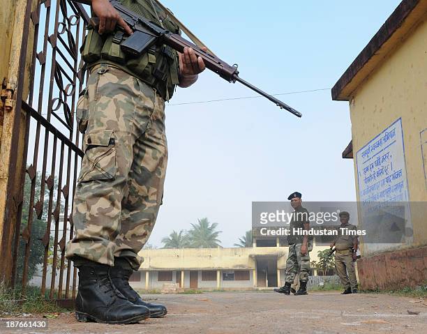 Paramilitary police guards a polling booth during the first phase of assembly elections of Chhattisgarh at Jagadalpur on November 11, 2013 in Bastar,...