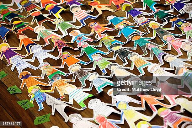 Volunteers put the finishing touches to a world record attempt at the longest chain of paper dolls ever at the Royal Festival Hall on November 11,...