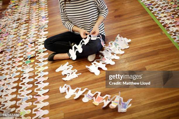 Volunteers put the finishing touches to a world record attempt at the longest chain of paper dolls ever at the Royal Festival Hall on November 11,...