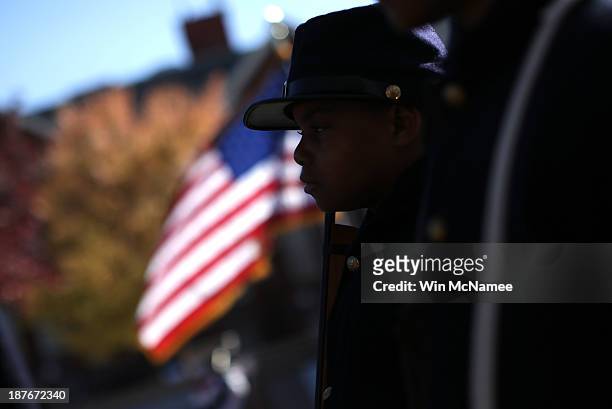 Joshua Terry, dressed in a Civil War military uniform, participates in a wreath-laying ceremony commemorating Veterans Day and honoring the Tuskegee...