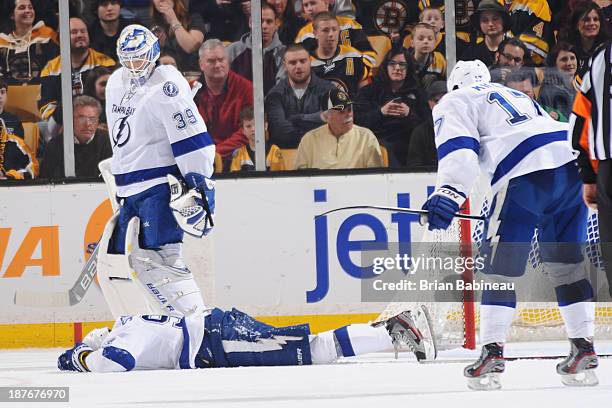Steven Stamkos of the Tampa Bay Lightning lays on the ice after hitting his leg on the goal post during a play against the Boston Bruins at the TD...