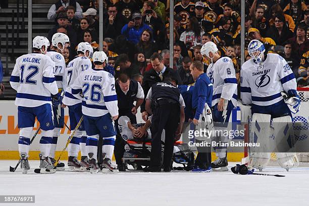 Steven Stamkos of the Tampa Bay Lightning lays on a stretcher after hitting his leg on the goal post during a play against the Boston Bruins at the...