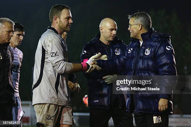 Tom King the goalkeeper of Shortwood United shakes hands with Micky Adams the manager of Port Vale after the final whistle during the FA Cup First...