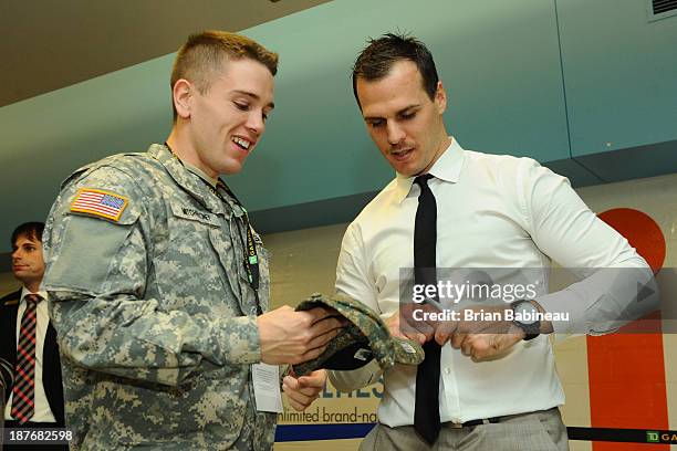 David Krejci of the Boston Bruins meets with members of the armed forces after the Military Appreciation night game against the Tampa Bay Lightning...