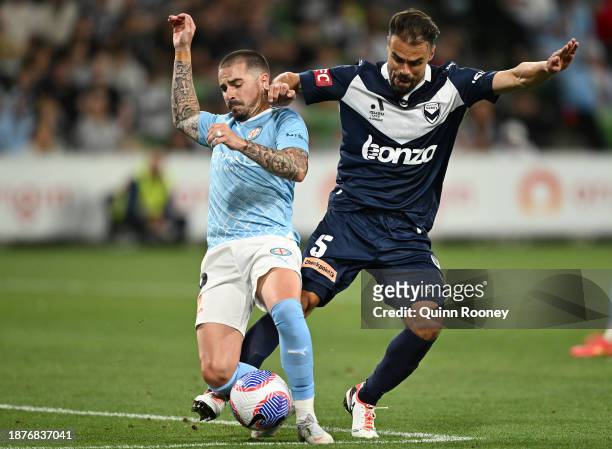 Jamie Maclaren of Melbourne City and Damien Da Silva of Melbourne Victory compete for the ball during the A-League Men round nine match between...