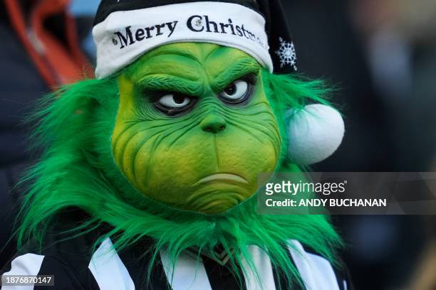 Newcastle United's fan wearing a mask of The Grinch attends the English Premier League football match between Newcastle United and Nottingham Forest...