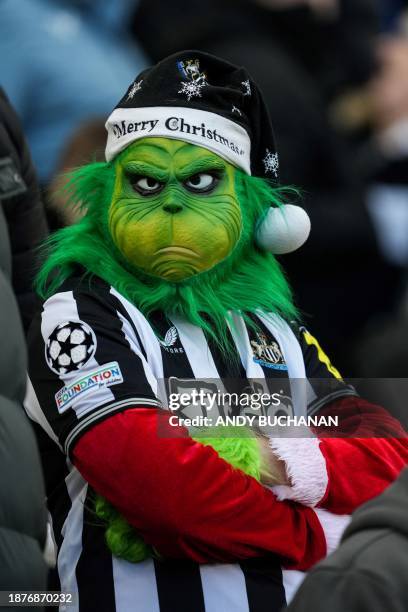 Newcastle United's fan wearing a mask of The Grinch attends the English Premier League football match between Newcastle United and Nottingham Forest...