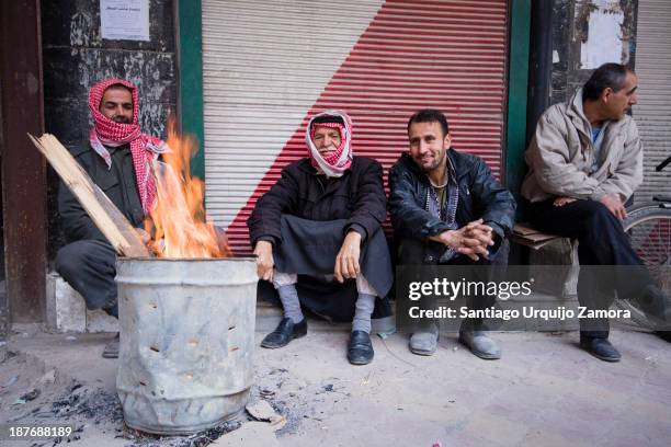 Syrian men warming up with a fire on a street of Damascus, Damascus, Damascus Governorate, Syria. Discontent against the government was strongest in...