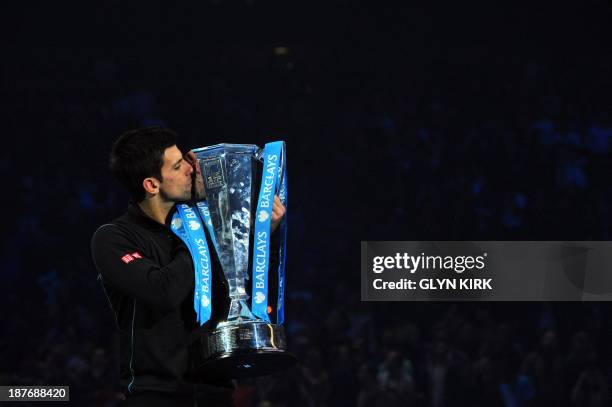 Serbia's Novak Djokovic kisses the Brad Drewett Trophy after beating Spain's Rafael Nadal in the singles final on the eighth day of the ATP World...