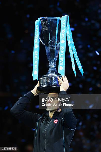 Novak Djokovic of Serbia lifts the trophy after his men's singles final match against Rafael Nadal of Spain during day eight of the Barclays ATP...