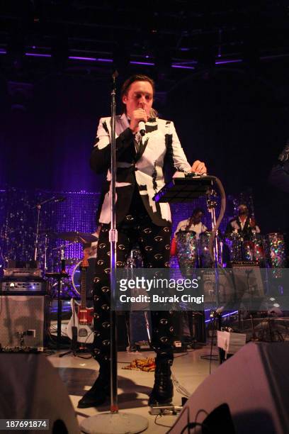Tim Kingsbury, Win Butker, Jeremy Gara and Richard Parry of Arcade Fire perform on stage at The Roundhouse on November 11, 2013 in London, England.