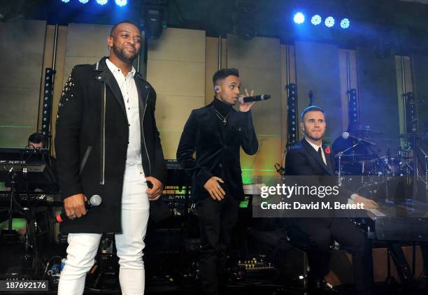 Oritse Williams and Aston Merrygold of JLS perform with Gary Barlow at the BBC Children in Need Gala hosted by Gary Barlow at The Grosvenor House...