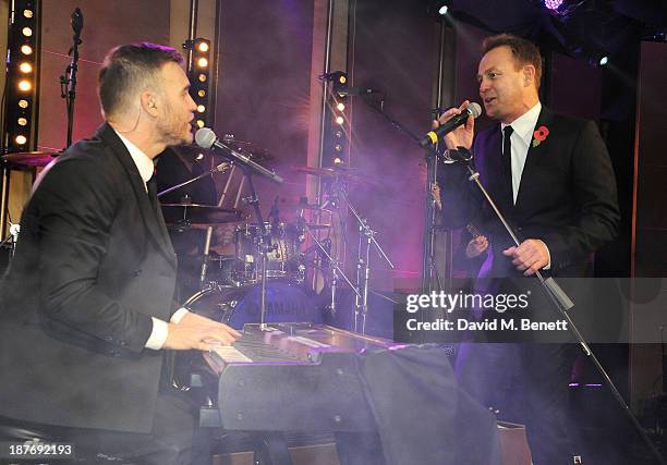 Gary Barlow and Jason Donovan perform at the BBC Children in Need Gala hosted by Gary Barlow at The Grosvenor House Hotel on November 11, 2013 in...