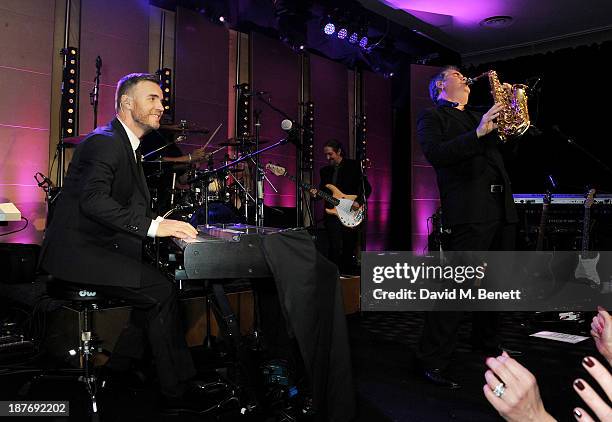 Gary Barlow and Jason Donovan perform at the BBC Children in Need Gala hosted by Gary Barlow at The Grosvenor House Hotel on November 11, 2013 in...