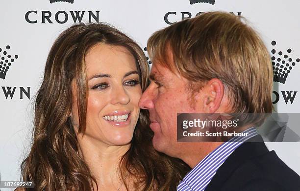 Shane Warne and Elizabeth Hurley pose as they attend the launch of the Shane Warne Foundation's Ambassador Program at Club 23 on November 12, 2013 in...