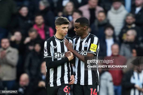 Newcastle United's Swedish striker Alexander Isak celebrates with Newcastle United's English midfielder Lewis Miley after shooting a penalty kick and...