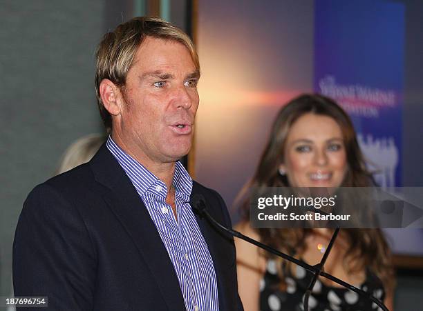 Shane Warne speaks as Elizabeth Hurley looks on during the launch of the Shane Warne Foundation's Ambassador Program at Club 23 on November 12, 2013...