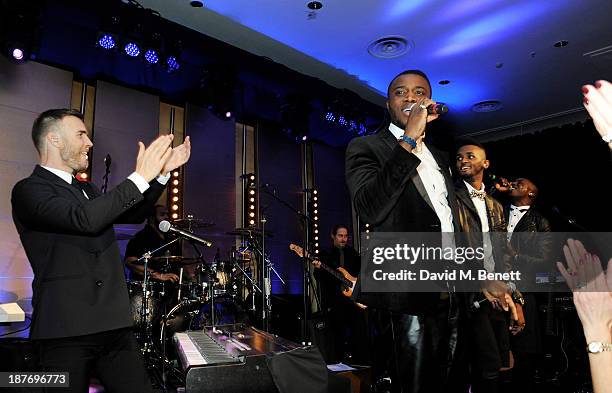 Gary Barlow performs with Joseph Ramsay, Sterling Ramsay and Kazeem Ajobe of Rough Copy the BBC Children in Need Gala hosted by Gary Barlow at The...