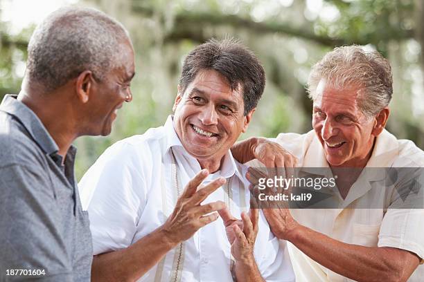 multi-ethnic men talking - alleen oudere mannen stockfoto's en -beelden