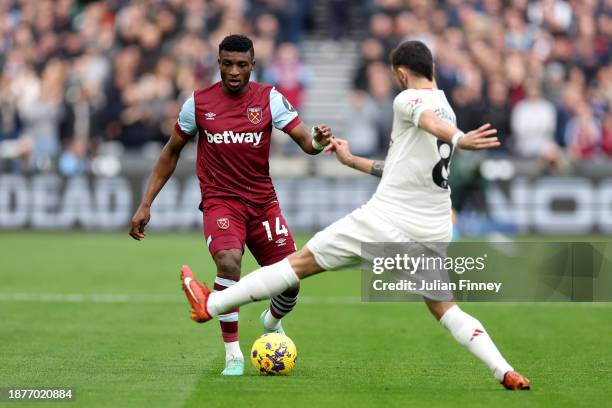 Mohammed Kudus of West Ham United is challenged by Bruno Fernandes of Manchester United during the Premier League match between West Ham United and...