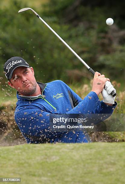 Marc Leishman of Australia plays out of the bunker during previews ahead of the 2013 Australian Masters at Royal Melbourne Golf Course on November...