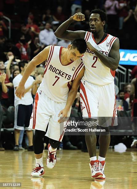 Jeremy Lin and Patrick Beverley of the Houston Rockets celebrate as time winds down in the second overtime period during the game against the Toronto...
