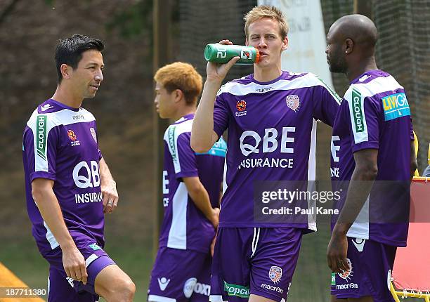 Jacob Burns and Michael Thwaite of the Glory talk with William Gallas before the start of his first training session with the club during a Perth...