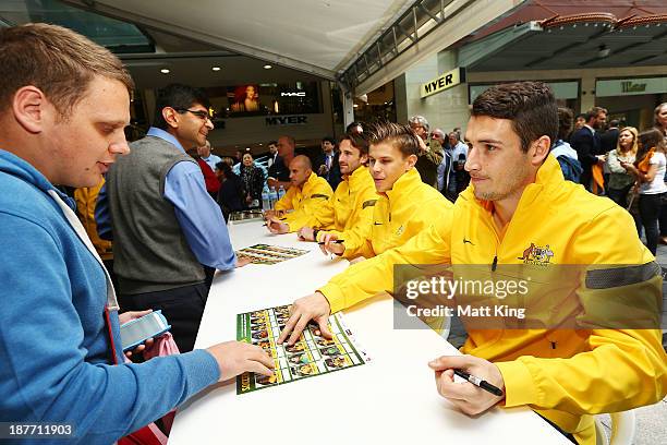 Matthew Leckie signs autographs for fans during an Australian Socceroos public appearance at Westfield Sydney on November 12, 2013 in Sydney,...