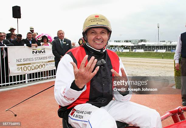 Ricky May, the driver of Terror to Love, winner of the New Zealand Trotting Cup, holds up 7 fingers representing 7 New Zealand Cup wins during New...
