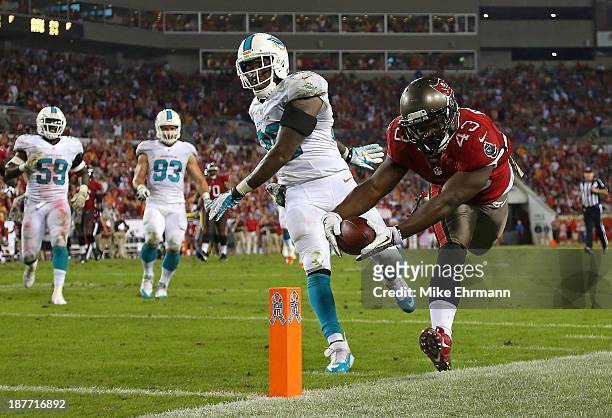 Bobby Rainey of the Tampa Bay Buccaneers scores a touchdown during a game against the Miami Dolphins at Raymond James Stadium on November 11, 2013 in...