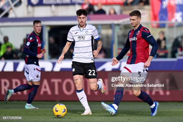 Stefan Posch of Bologna FC passes the ball whilst under pressure from Rafael Toloi of Atalanta BC during the Serie A TIM match between Bologna FC and...
