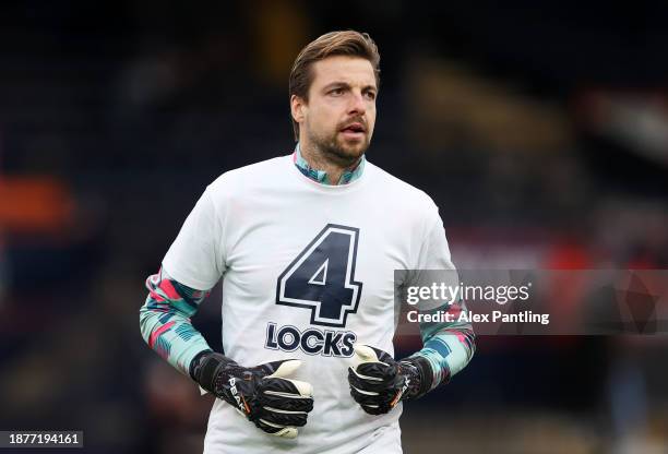 Tim Krul of Luton Town warms up whilst wearing a warm up shirt in support of teammate Tom Lockyer prior to the Premier League match between Luton...