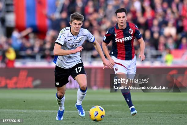 Charles De Ketelaere of Atalanta BC runs with the ball whilst under pressure from Nikola Moro of Bologna FC during the Serie A TIM match between...