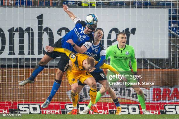 Fabian Klos of Bielefeld, Paul Will of Dresden and Sam Schreck of Bielefeld fight for the ball during the 3. Liga match between Arminia Bielefeld and...
