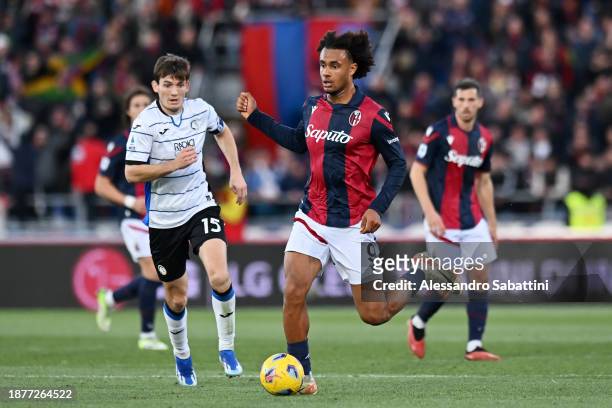 Joshua Zirkzee of Bologna FC on the ball whilst under pressure from Marten de Roon of Atalanta BC during the Serie A TIM match between Bologna FC and...