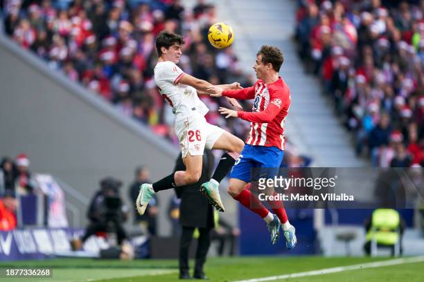 Rodrigo Riquelme of Atletico de Madrid competes for the ball with Juanlu Sanchez of Sevilla FC during the LaLiga EA Sports match between Atletico de...