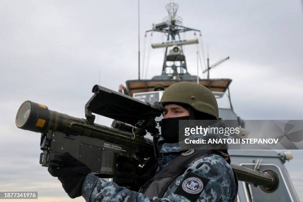 Ukrainian serviceman holds a MANPADS "Stinger" anti-aircraft weapon as they scan for possible air targets, onboard a Maritime Guard of the State...