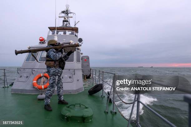 Ukrainian serviceman holds a MANPADS "Stinger" anti-aircraft weapon as they scan for possible air targets, onboard a Maritime Guard of the State...