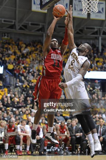 Forward Aaron Adeoye of the Western Kentucky Hilltoppers puts up a shot against forward Chadrack Lufile of the Wichita State Shockers during the...