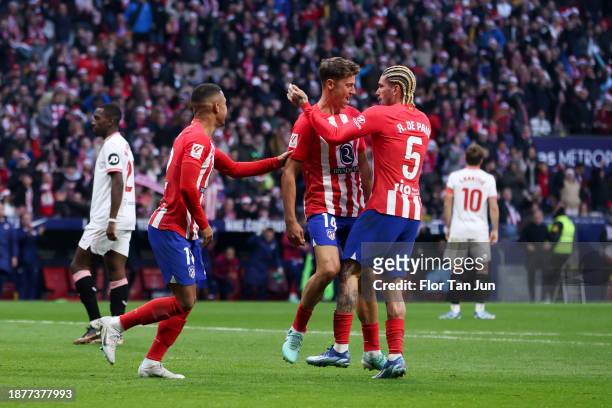 Marcos Llorente of Atletico de Madrid celebrates with teammates Rodrigo De Paul and Samuel Lino after scoring the team's firts goal during the LaLiga...