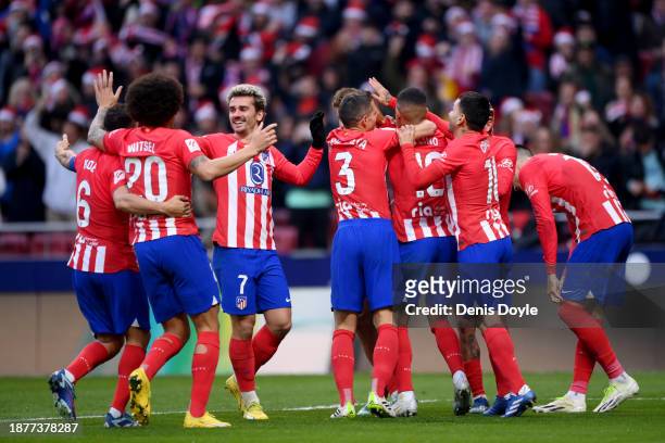 Marcos Llorente of Atletico Madrid celebrates with teammates after scoring their team's first goal during the LaLiga EA Sports match between Atletico...