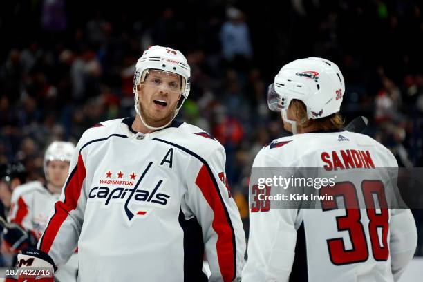 John Carlson of the Washington Capitals talks with Rasmus Sandin during the game against the Columbus Blue Jackets at Nationwide Arena on December...