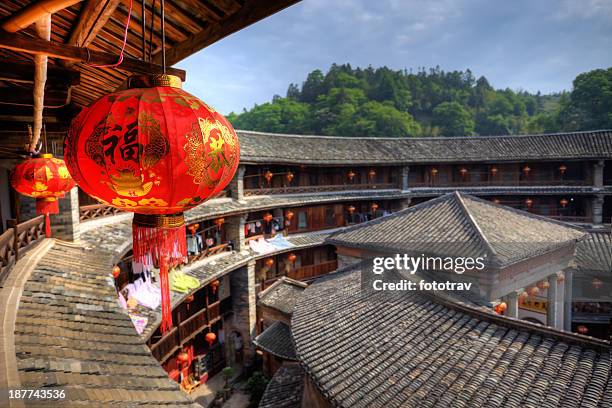 red chinese lantern in a hakka tulou traditional housing, fujian - xiamen municipality stock pictures, royalty-free photos & images