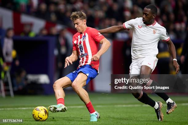 Marcos Llorente of Atletico de Madrid competes for the ball with Boubakary Soumare of Sevilla FC during the LaLiga EA Sports match between Atletico...