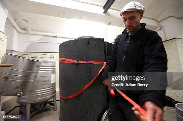 Johannes Heidenpeter, owner of Heidenpeters brewery, secures insulation around a lauter tun while brewing Thirsty Lady American Pale Ale beer on...