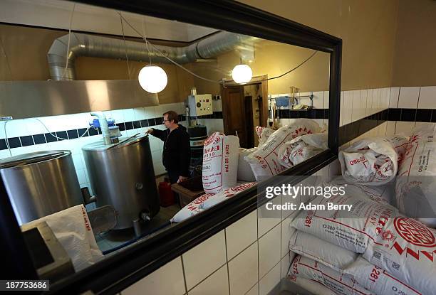 Philipp Krokamp, owner of Hops & Barley brewery, looks into the lauter tun of a pilsner beer he is brewing as it boils on November 12, 2013 in...