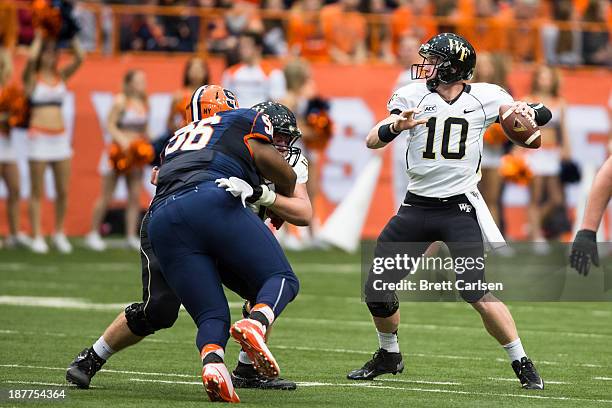 Tanner Price of Wake Forest Demon Deacons drops back to pass against Syracuse Orange on November 2, 2013 at the Carrier Dome in Syracuse, New York....