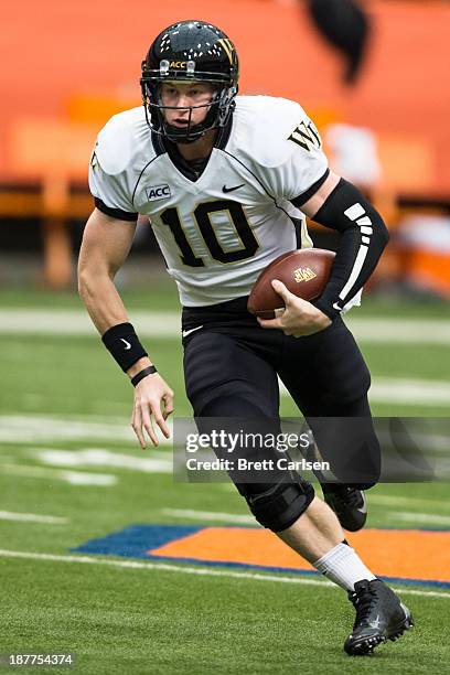 Tanner Price of Wake Forest Demon Deacons scrambles during a game against Syracuse Orange on November 2, 2013 at the Carrier Dome in Syracuse, New...